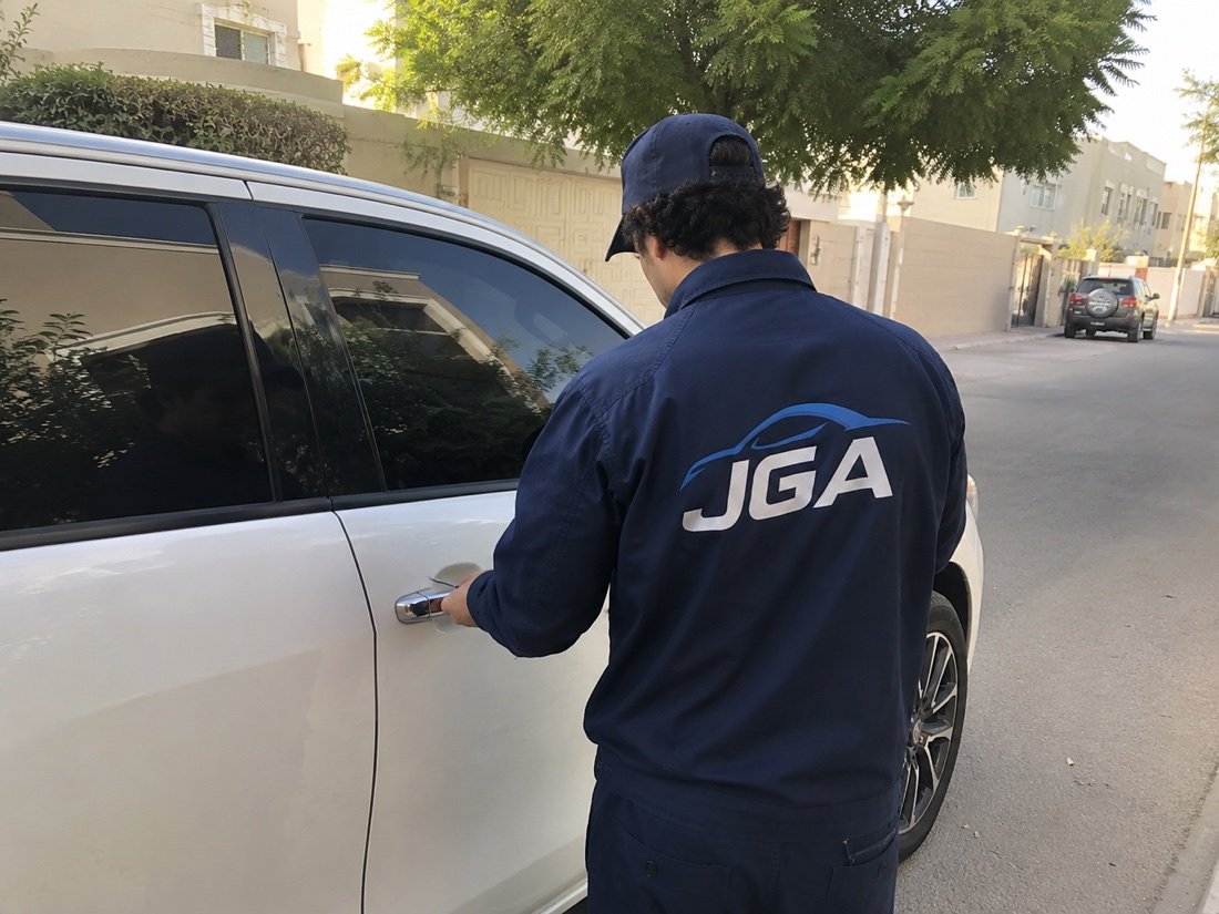 Technician opening a locked car door with professional tools
